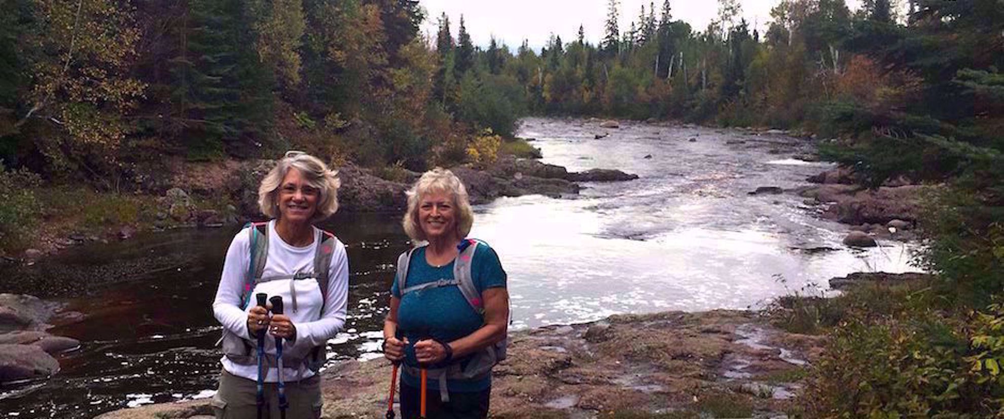 Picture of Autumn on the Superior Hiking Trail Women smiling by river on superior hiking trail