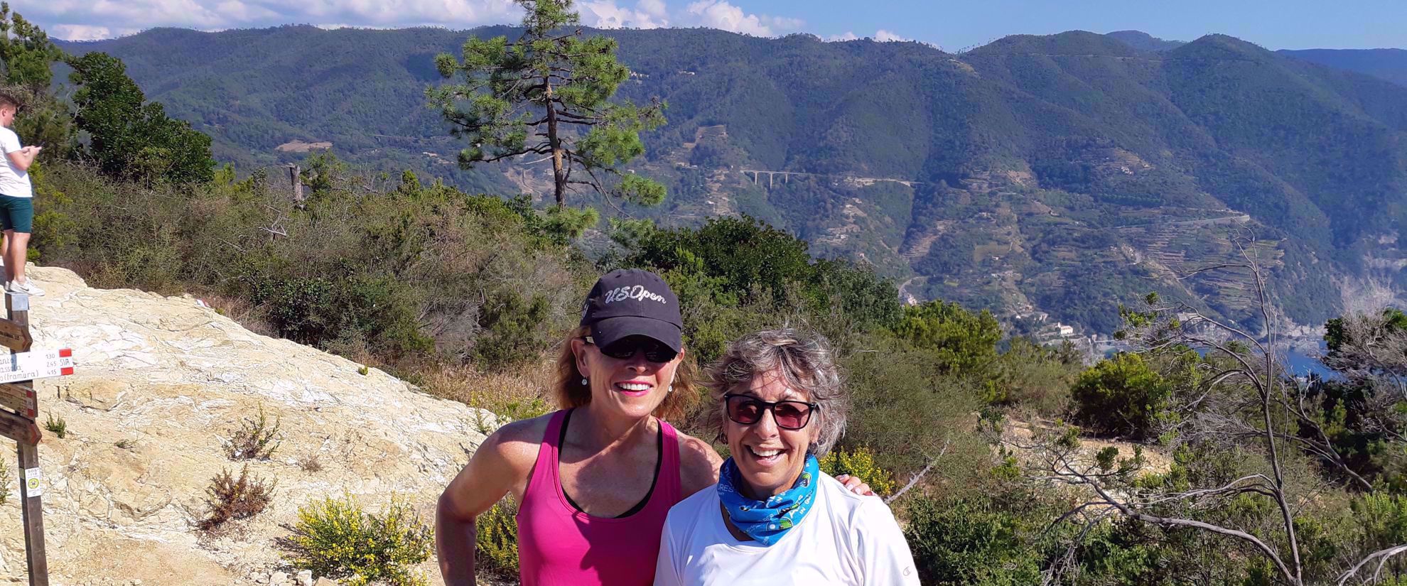 Women smiling during hike through italian riviera
