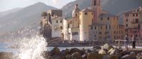 Picture of Cinque Terre and the Italian Riviera Waves crashing on rocks in italy with old building in background