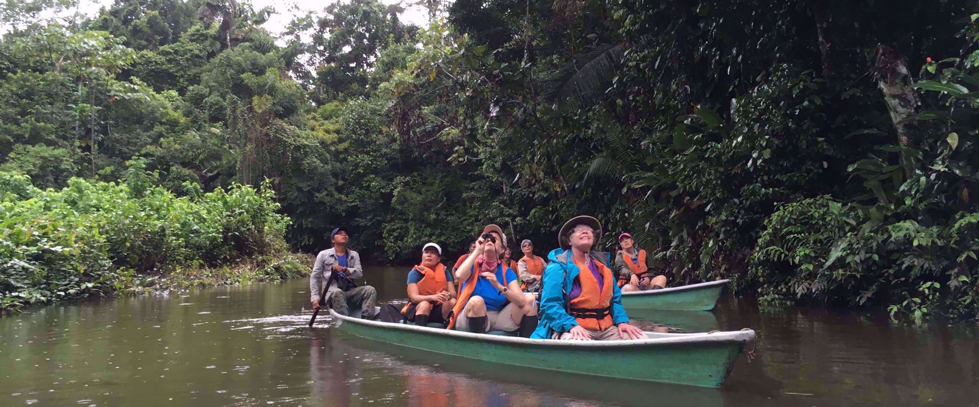 group travel tour canoe through amazon river