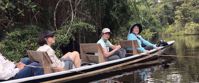 women smiling from canoe ecuador travel tour