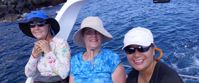 Picture of Exploring the Galapagos Islands by Land women smiling on boat tour through galapagos islands