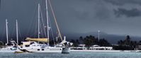 sailboats in harbor on cloudy day in galapagos