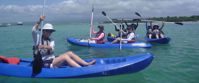 Picture of Exploring the Galapagos Islands by Land women kayaking in water around the galapagos on group travel tour