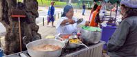 Picture of Exploring the Galapagos Islands by Land woman preparing local cuisine on galapagos islands