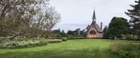 church chapel in green field with trees