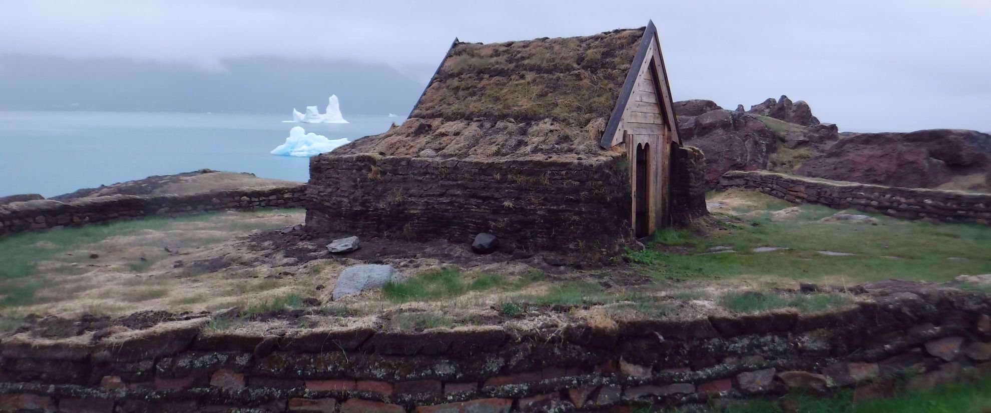 rustic shack near greenland coastline