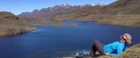 woman enjoying beautiful lake and sunshine in greenland