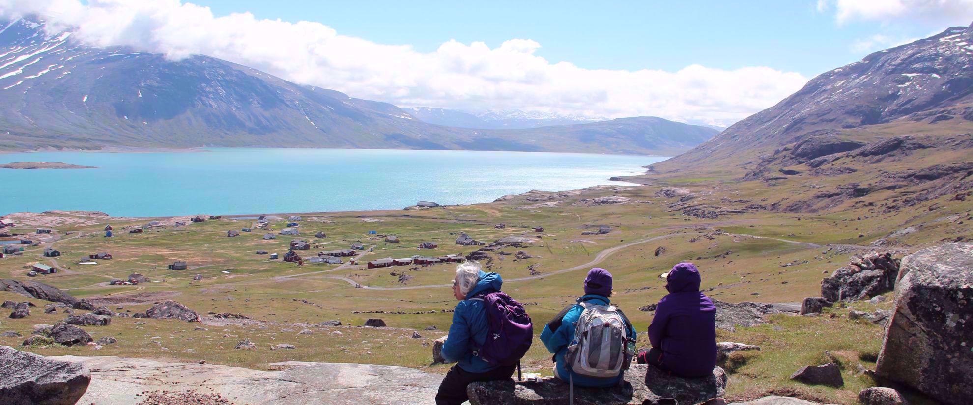 women enjoying view of turquoise lake in greenland