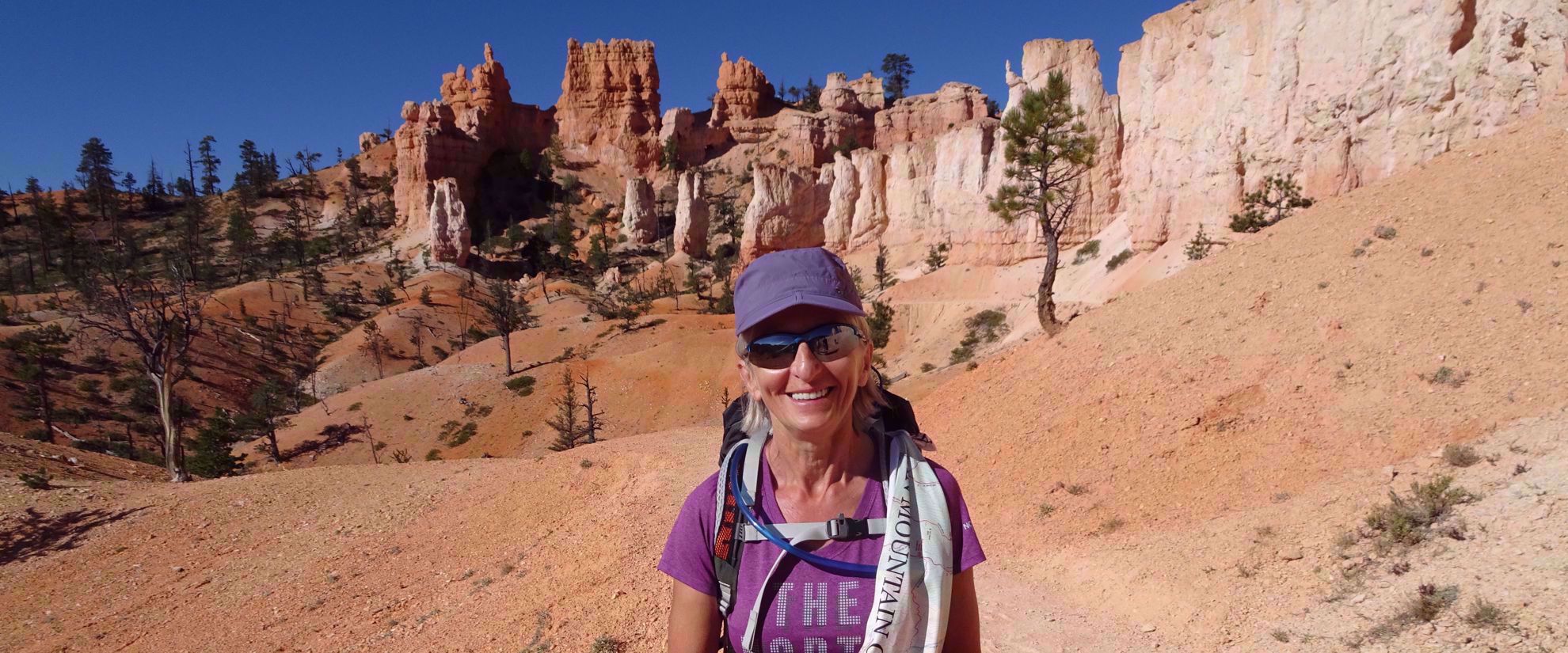woman smiles on hike in bryce national park