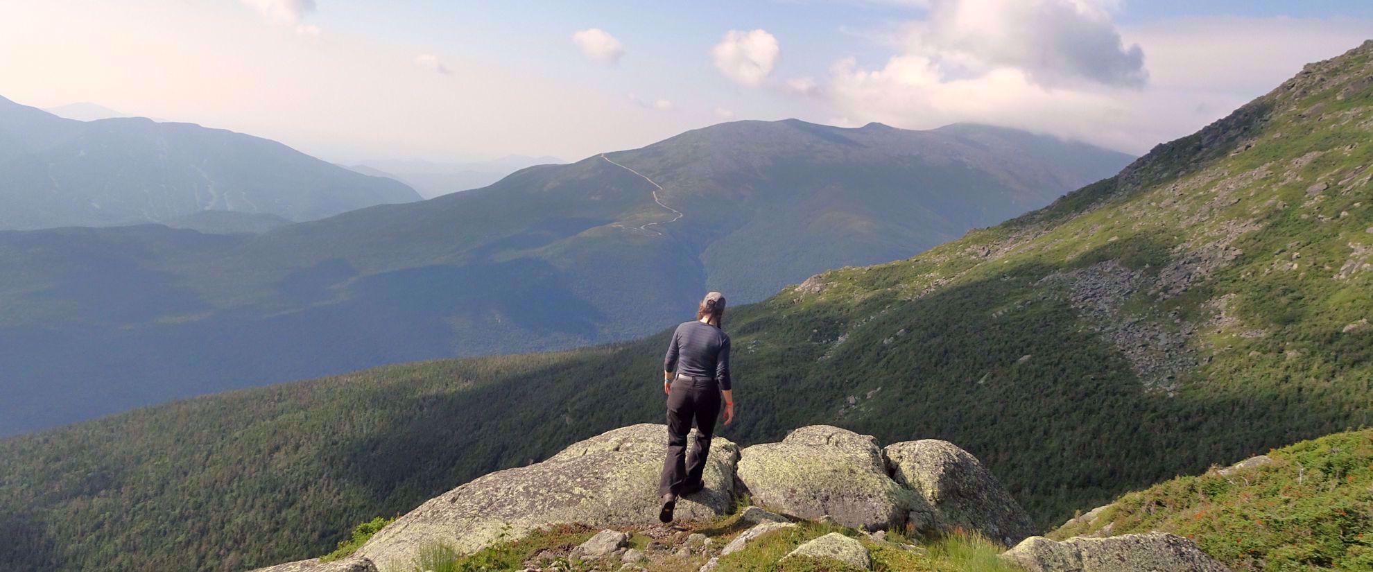 woman on rock enjoys view of valley on appalachian trail