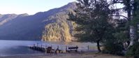 Picture of Pacific Northwest Escape: The San Juan Islands & Olympic National Park sun shining on mountain by lake with dock and chairs
