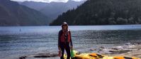 woman with yellow kayak prepares to kayak olympic national park