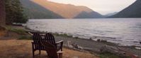 chairs overlooking beautiful lake view with sun on mountains