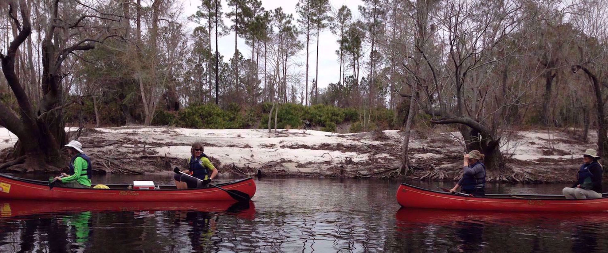 Picture of On the Suwannee River women laughing and smiling in red kayaks on suwannee river