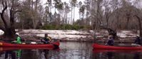 Picture of On the Suwannee River women laughing and smiling in red kayaks on suwannee river