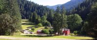 red house with white trim in rural oregon