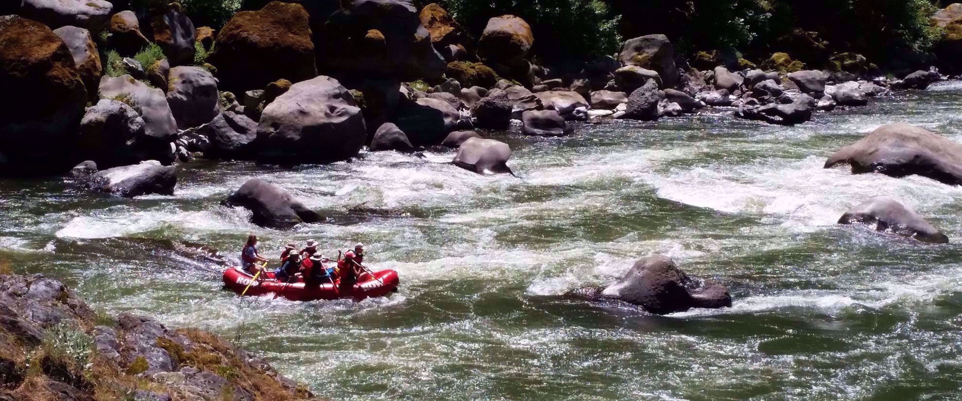 rafting through rogue river rapids with rocks