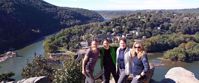four women smiling at lookout point in harpers ferry