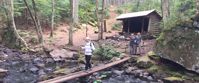 Picture of Slackpacking Maine woman crossing log bridge in maine
