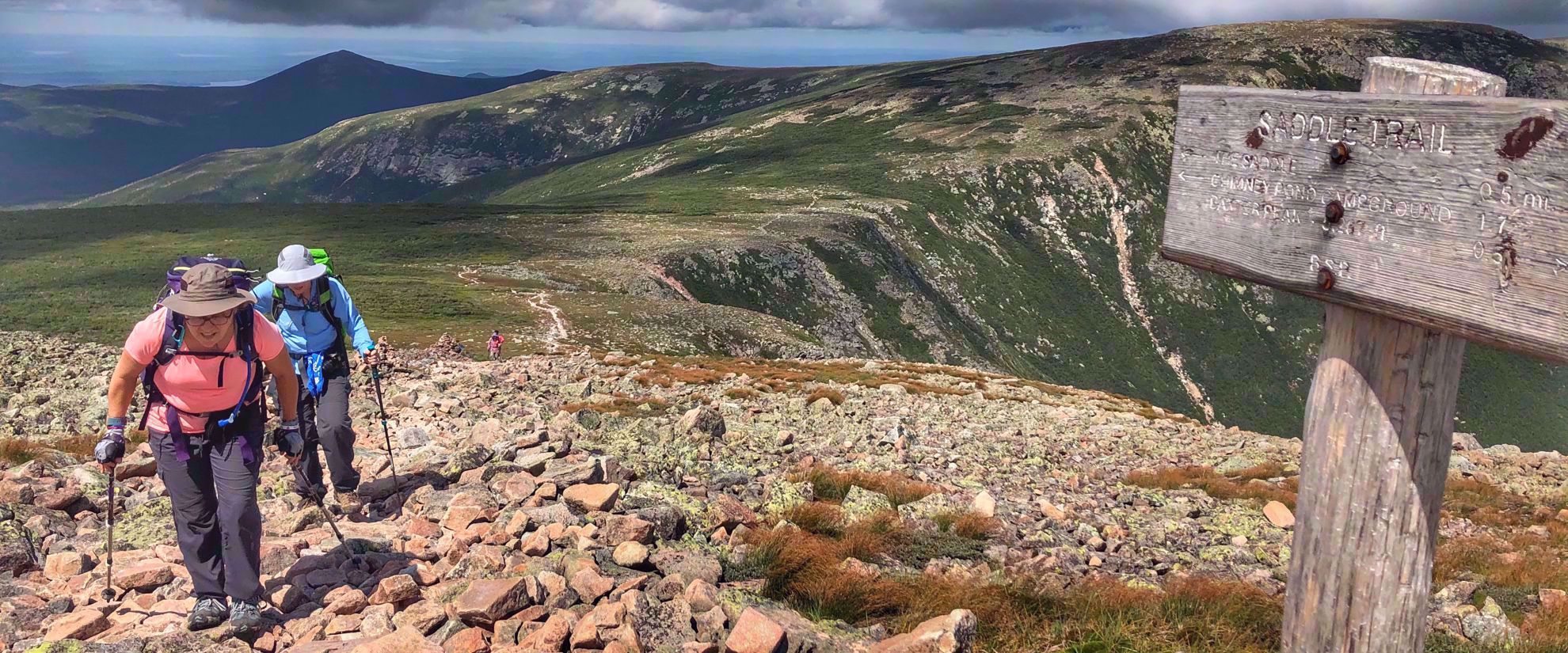 Picture of Slackpacking Maine women hiking to saddle trail sign