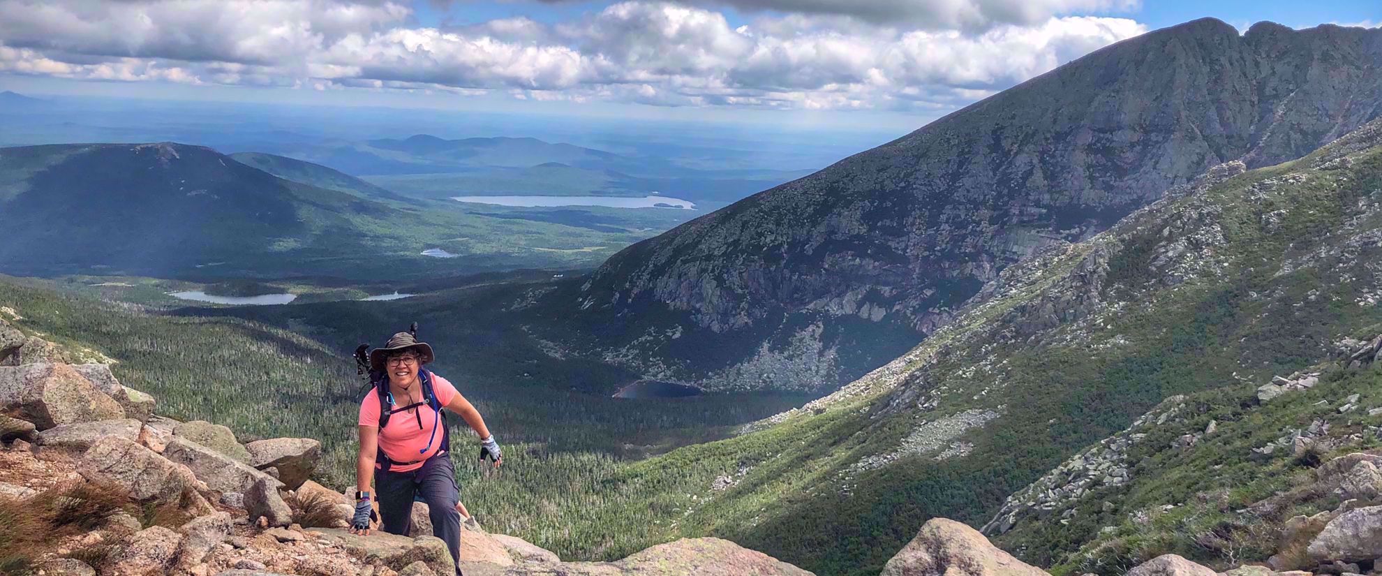 Picture of Slackpacking Maine woman smiles with beautiful view of valley behind her