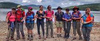 Picture of Slackpacking Maine women pose for group photo by lake during travel tour