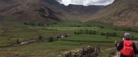 Picture of Tramping the Lake District women hiking through green meadows in Grasmere lake district uk
