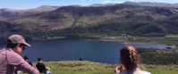 Picture of Tramping the Lake District enjoying lunch with view of lake on hike in grasmere uk