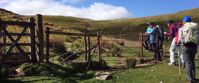 Picture of Tramping the Lake District women walking through gate on trail in united kingdom