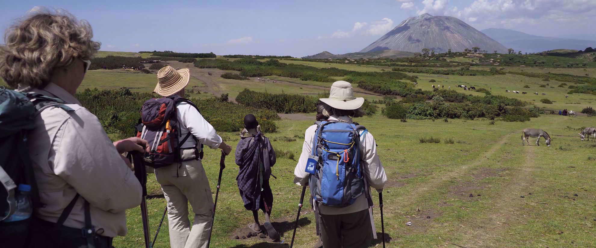 women hike on group walking tour in tanzania