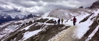 hiking snow covered italian mountains with women's travel tour