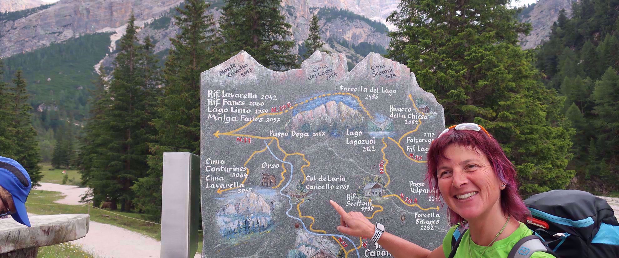 woman points to cal de locia cancello sign northern italian alps