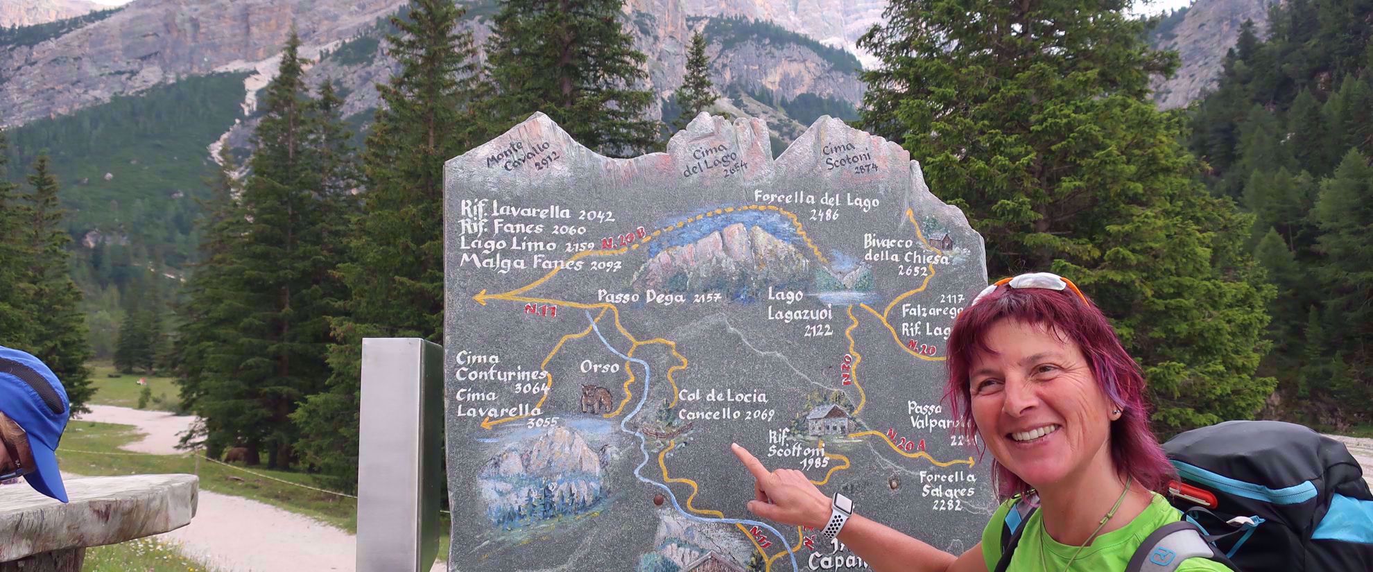 Picture of Hiking Italy's Northern Alps woman points to cal de locia cancello sign northern italian alps
