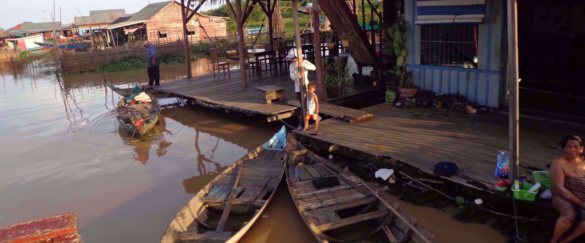 local family on dock with wooden kayaks