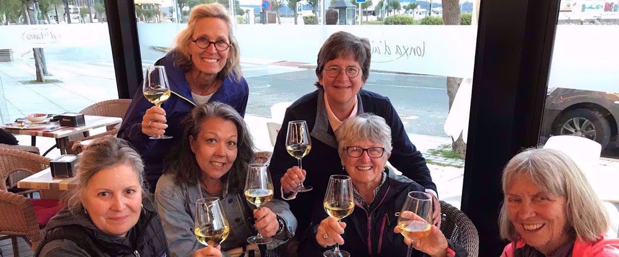 Toast Women toasting with wine on group travel tour to spain