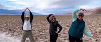 Picture of Death Valley Delights women spelling out AGC with their arms in death valley