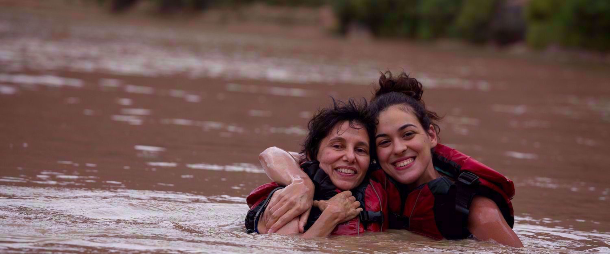 Two women smiling in river