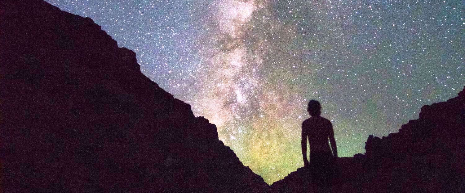 Starry sky in Utah, silhouette framed by canyon and backdrop of stars