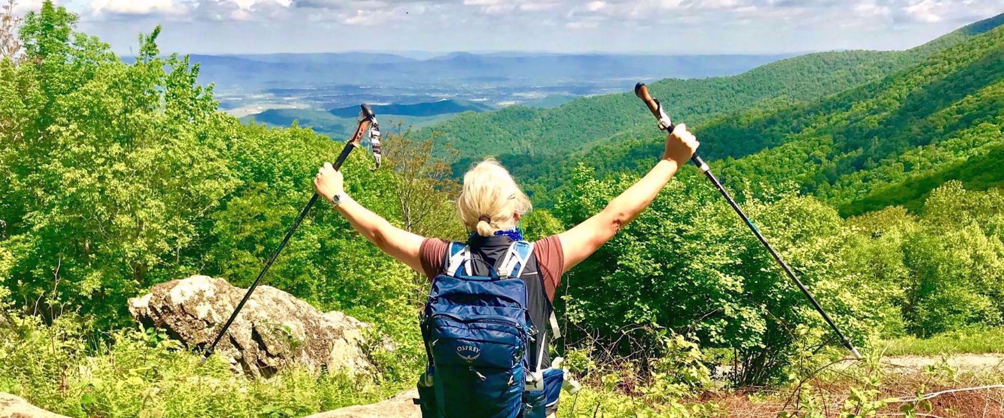 woman with osprey backpack and hiking poles appalachian trail