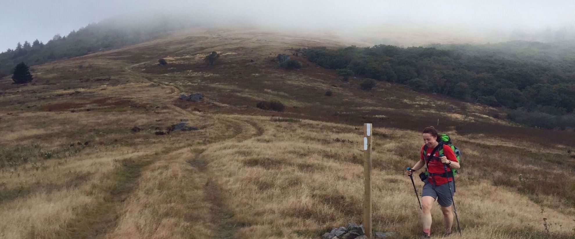Picture of Slackpacking Virginia women hiking though misty meadow in virginia