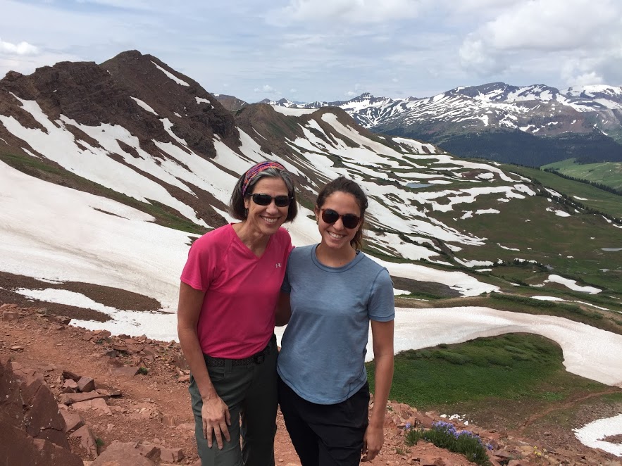 Mother and daughter standing in front of mountains